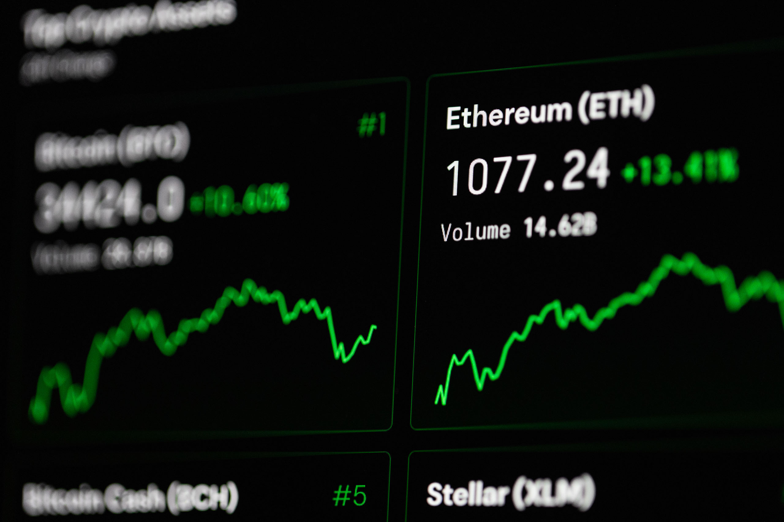 Close-up of cryptocurrency market data with Ethereum and Bitcoin prices on screen.
