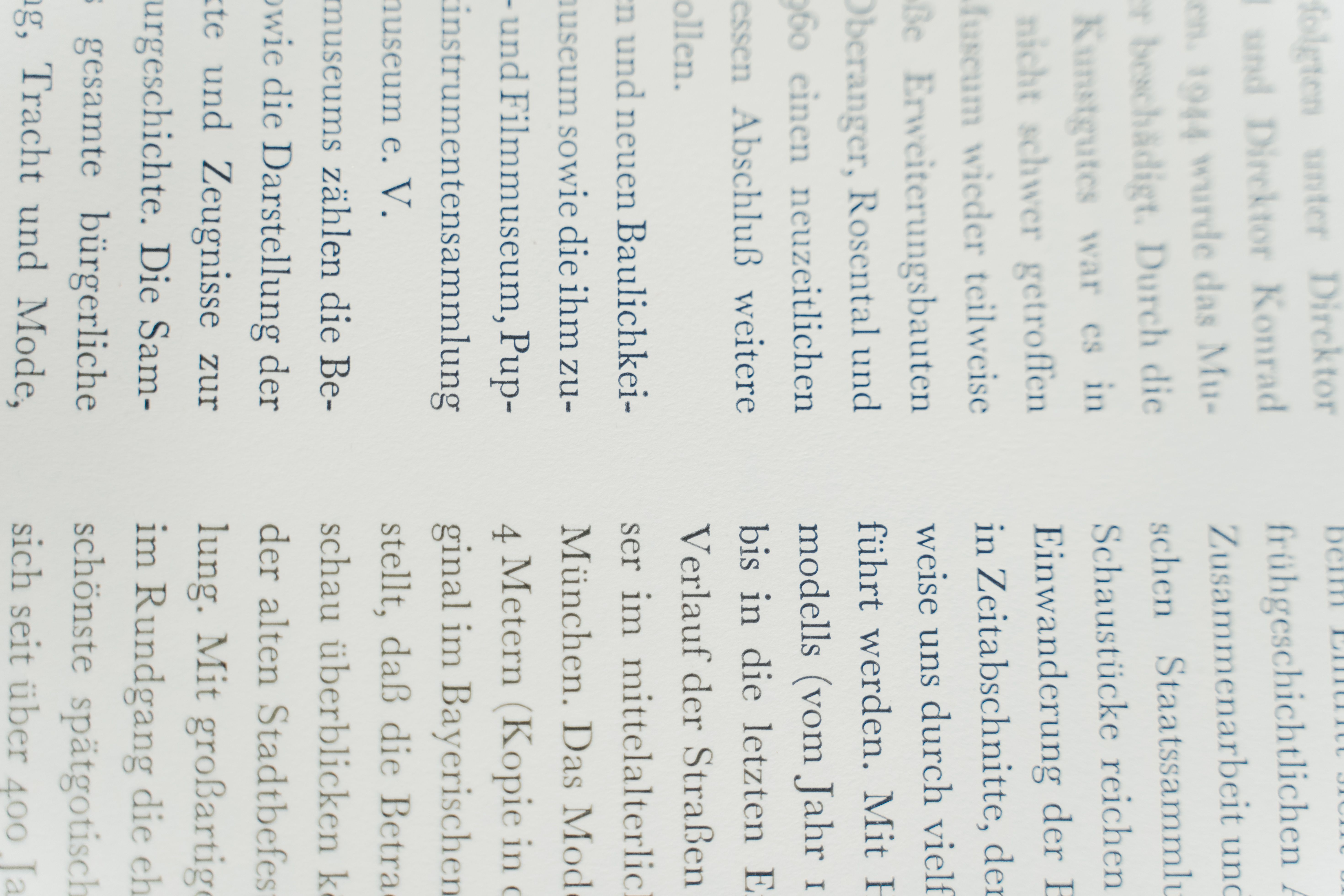 Detailed close-up of German text printed on white paper, focusing on typography.
